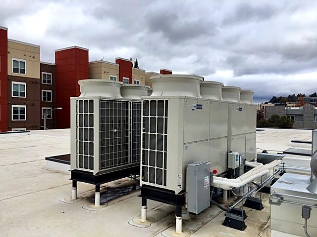 Mitsubishi VRF condensing units on a commercial rooftop in Eugene